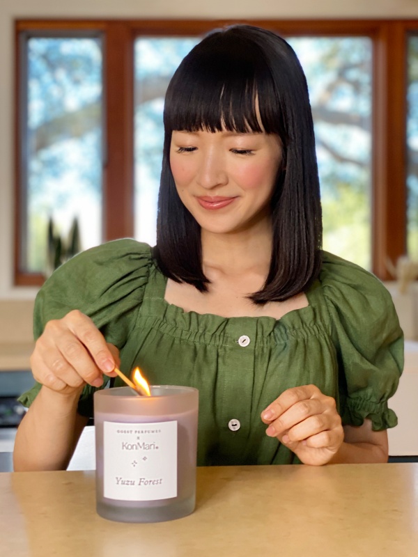 Marie Kondo lighting a Goest x KonMari Yuzu Forest Candle
