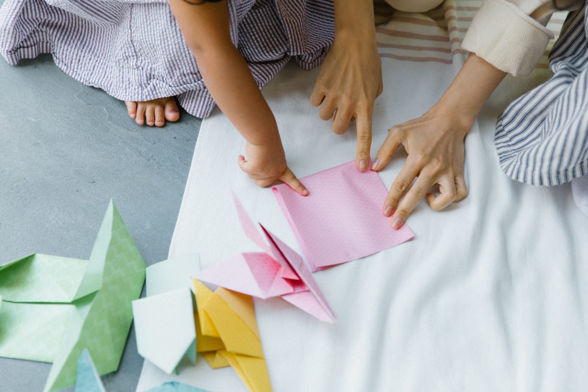 Marie and child folding origami
