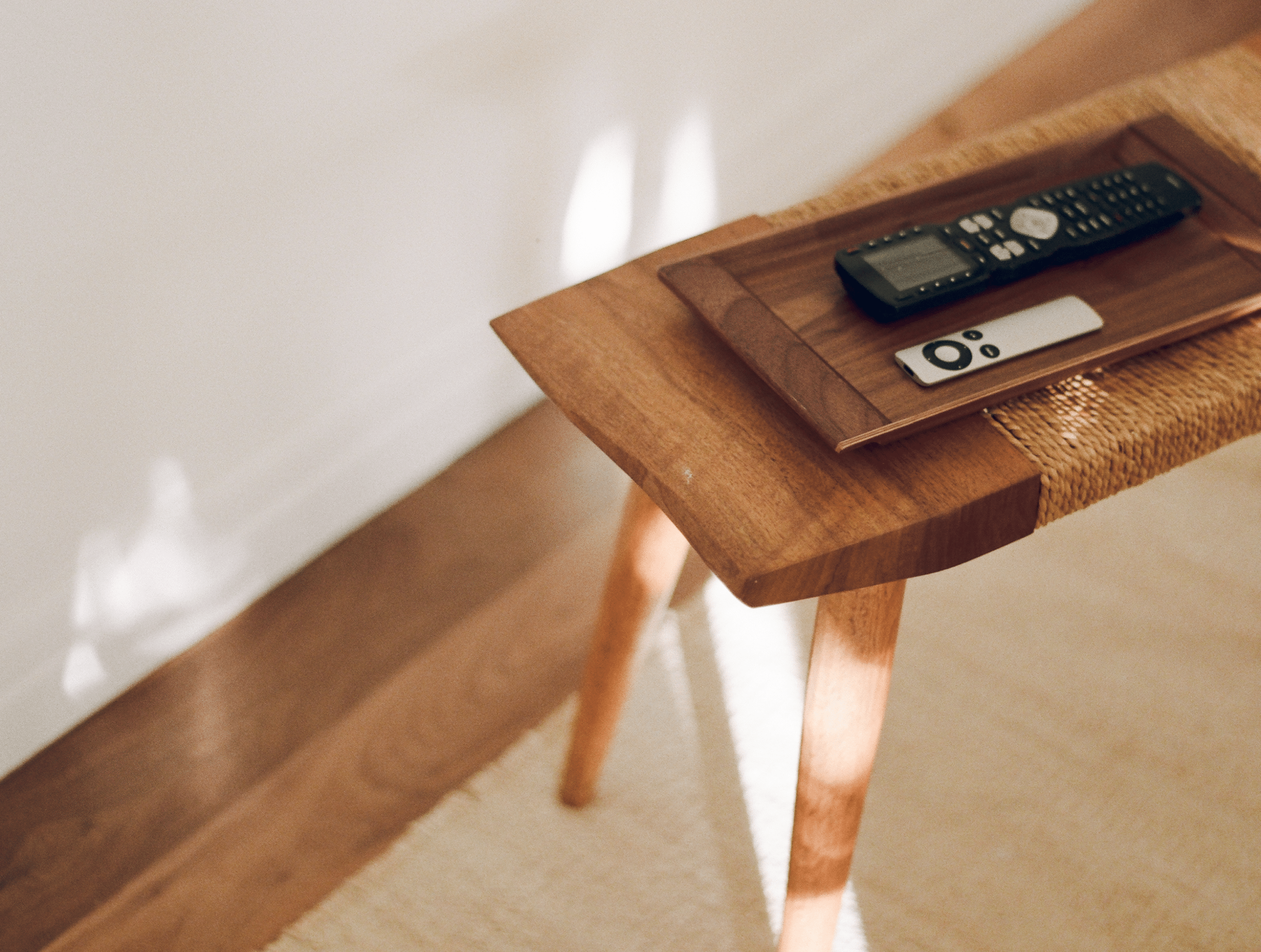 TV remote in its home (a tray near the TV).