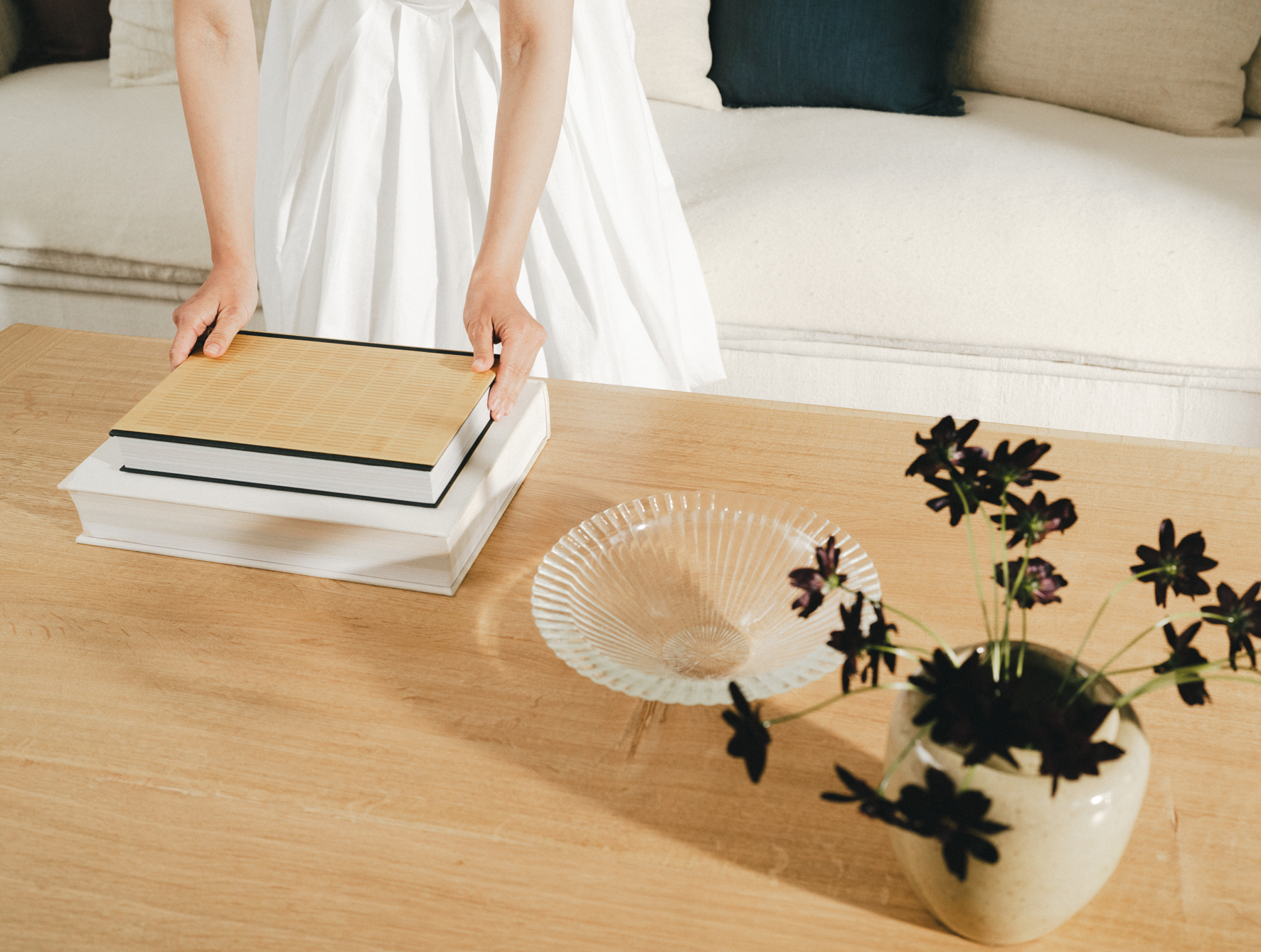 Marie Kondo places flowers on a table.