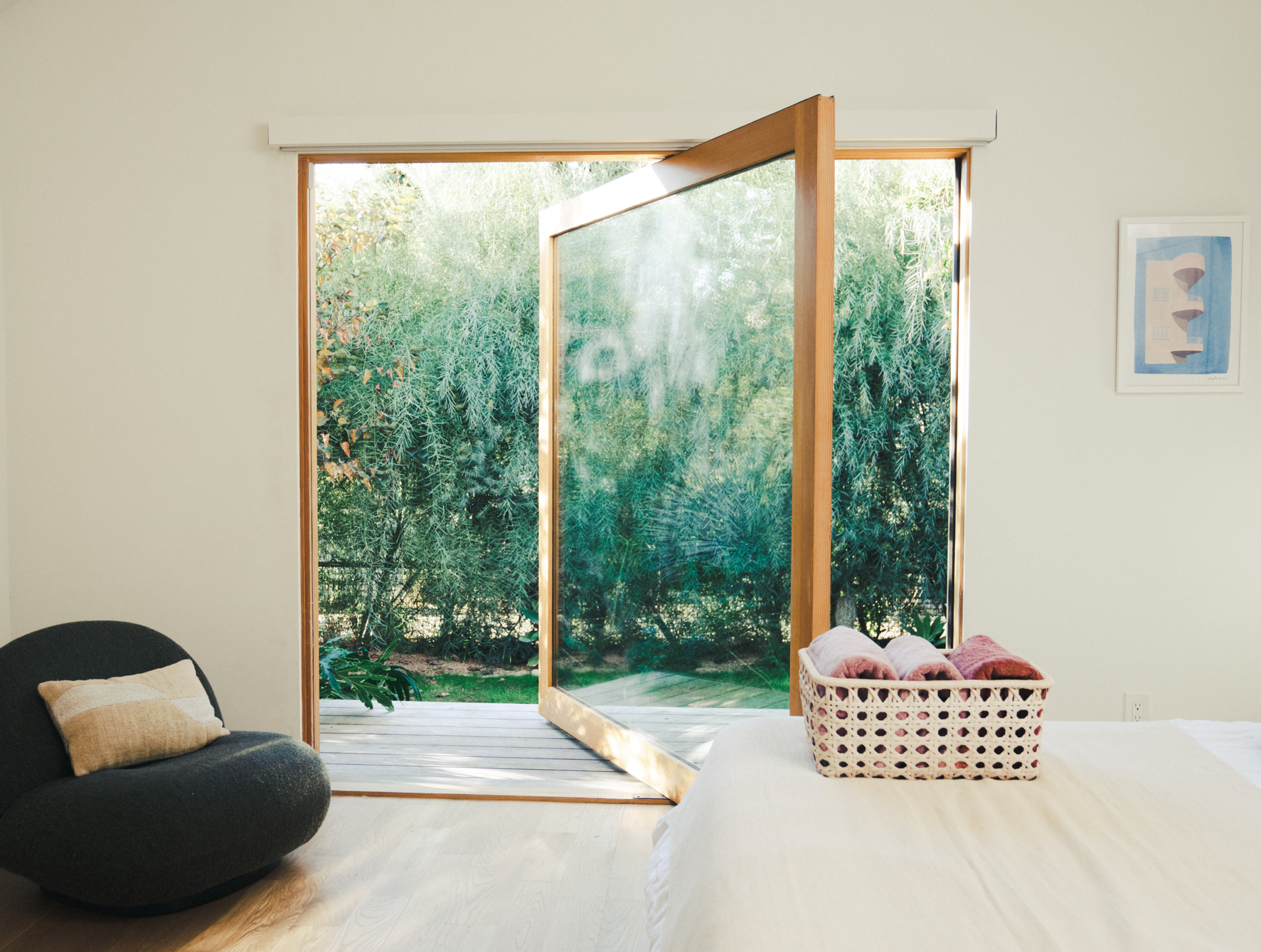 A window lets fresh air in to rest the room.